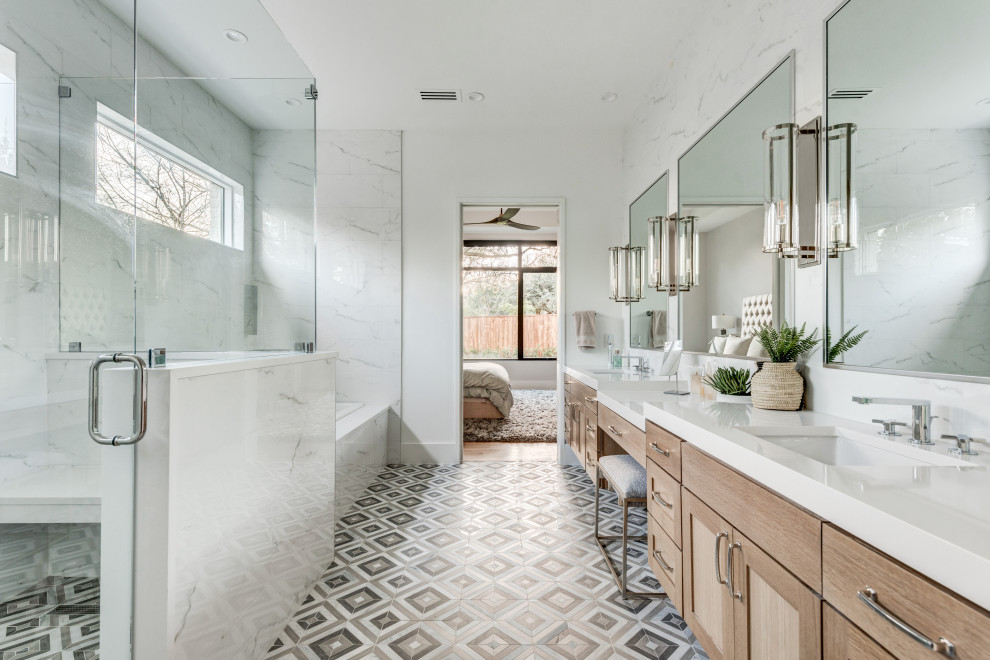 This is an example of an expansive transitional master bathroom in Dallas with shaker cabinets, light wood cabinets, a drop-in tub, an alcove shower, gray tile, white tile, porcelain tile, white walls, mosaic tile floors, an undermount sink, multi-coloured floor, a hinged shower door, white benchtops and a built-in vanity.