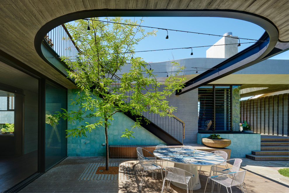 Photo of a mid-sized midcentury patio in Perth.
