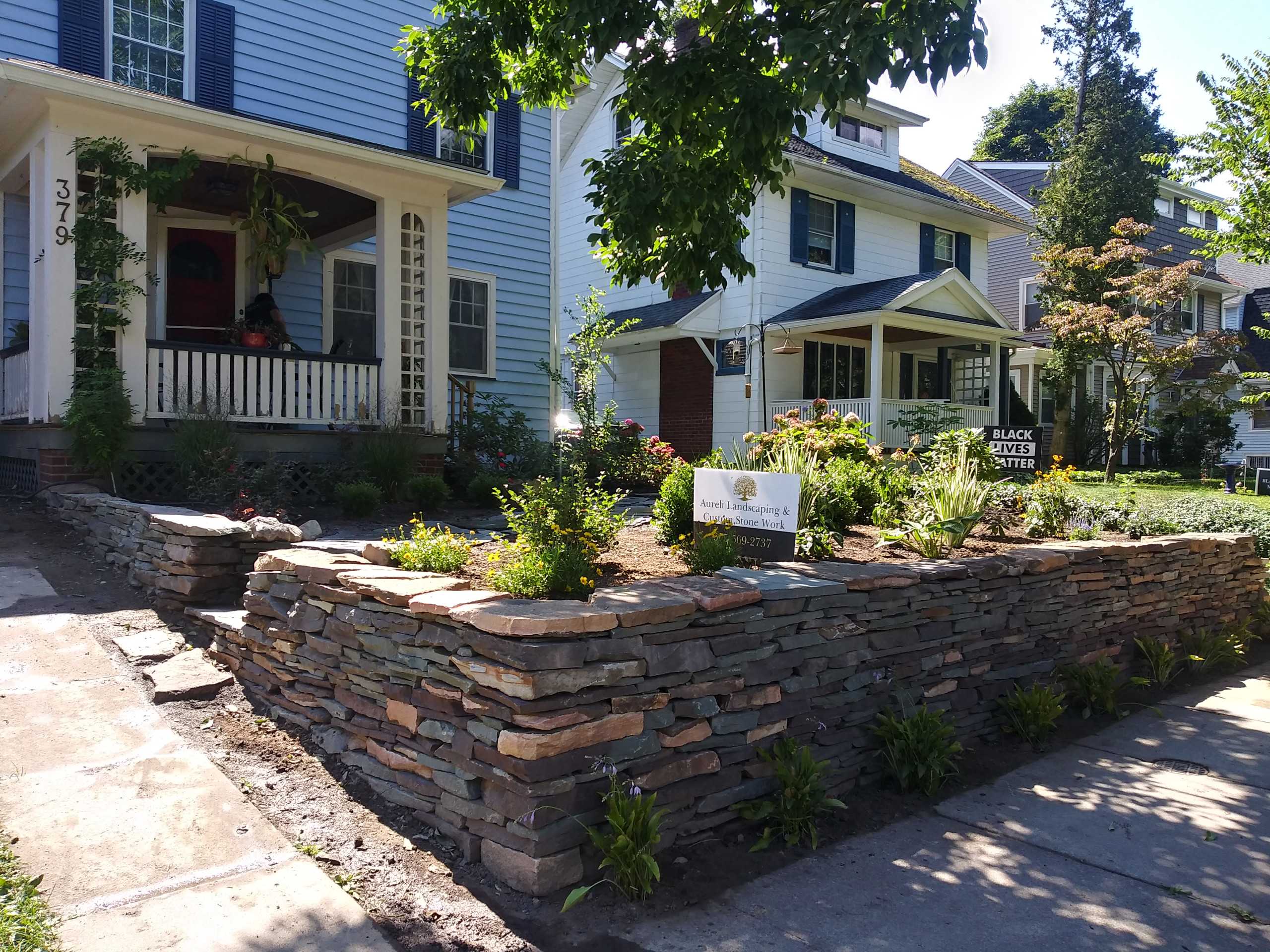 This project was a full make over of a small city front yard. The steps were failing and problematic slope in front at the side walk. We redesigned with a dry stalked wall, relocated the steps and add