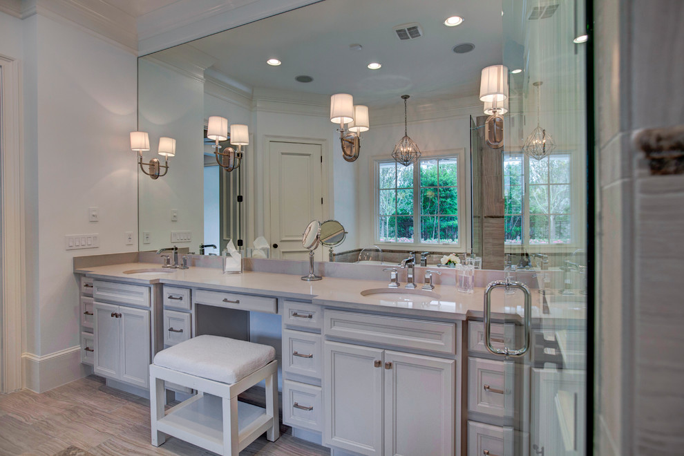 Transitional master bathroom in Orlando with an undermount sink, white cabinets, a freestanding tub, white tile, ceramic tile, white walls and travertine floors.
