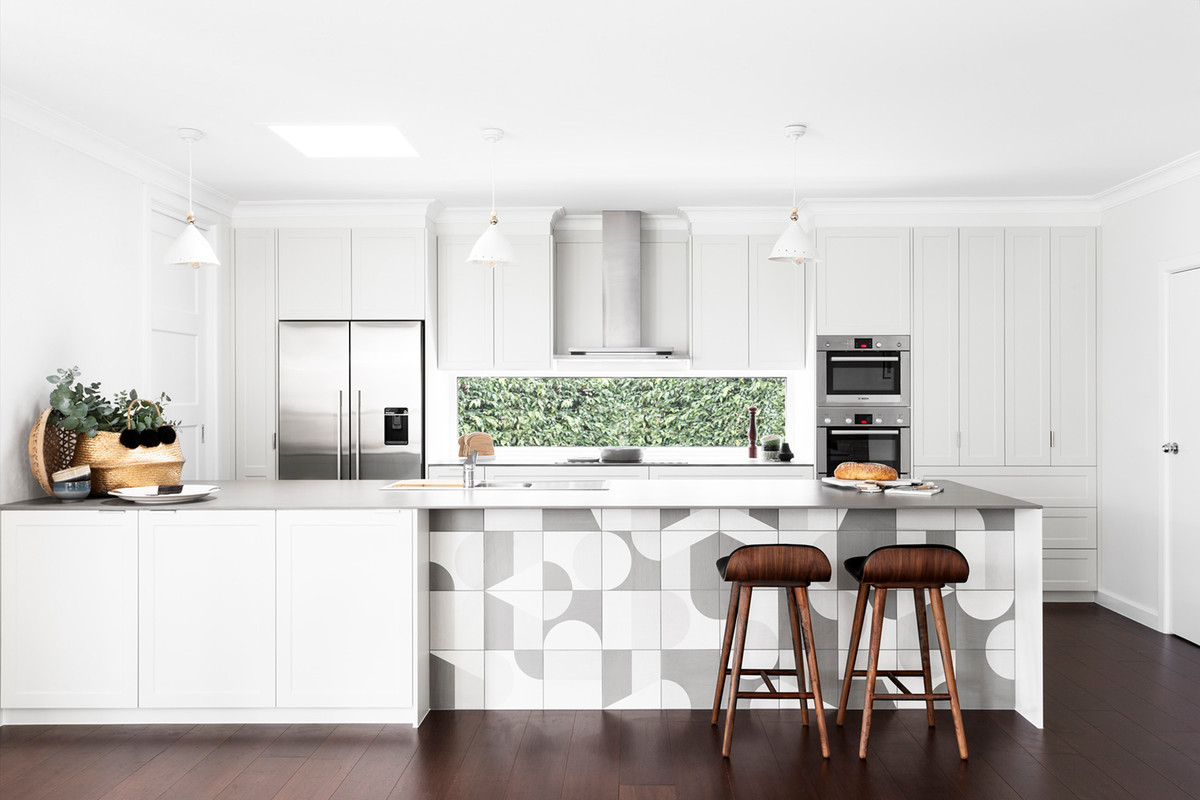 Inspiration for a mid-sized scandinavian galley open plan kitchen in Melbourne with a drop-in sink, shaker cabinets, white cabinets, window splashback, stainless steel appliances, dark hardwood floors, a peninsula, concrete benchtops, brown floor and white benchtop.