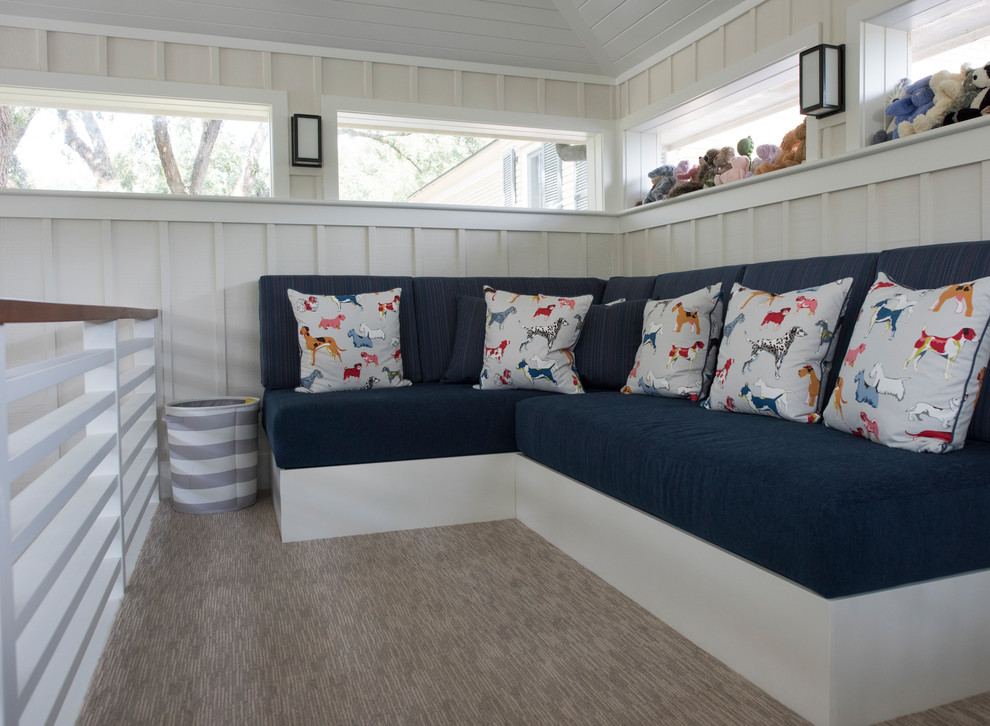 This is an example of a small transitional gender-neutral kids' playroom for kids 4-10 years old in Charleston with beige walls, carpet and beige floor.