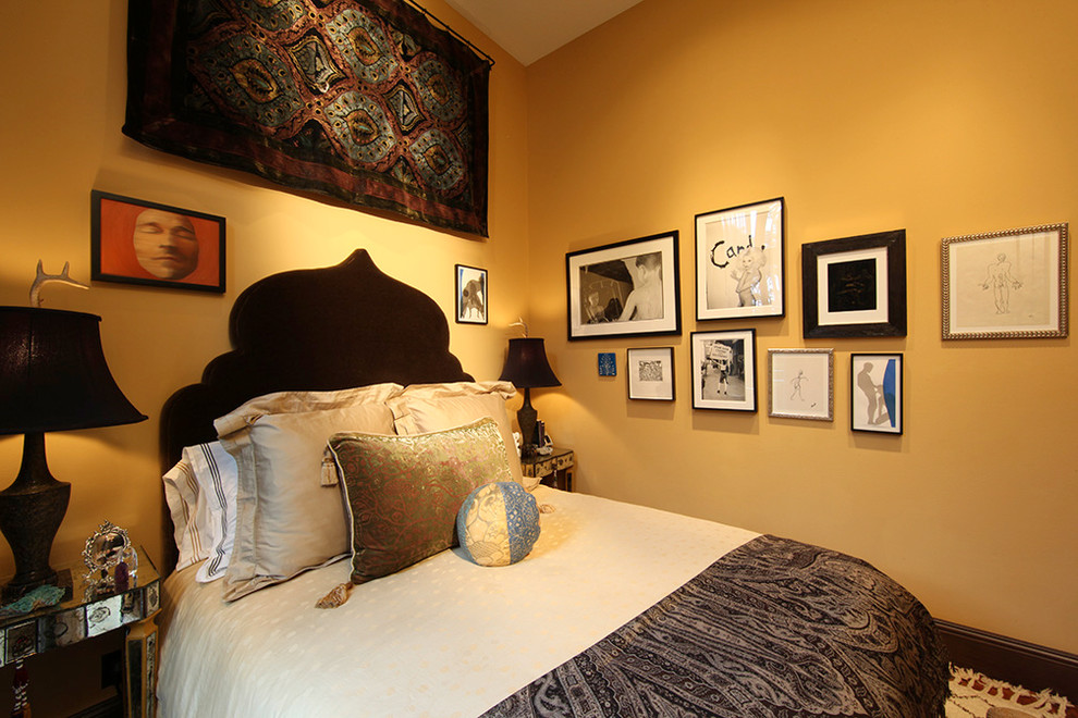 Inspiration for a small eclectic master medium tone wood floor bedroom remodel in San Francisco with yellow walls