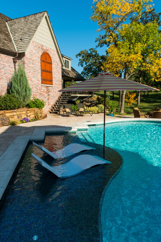 Large traditional backyard custom-shaped lap pool in Houston.