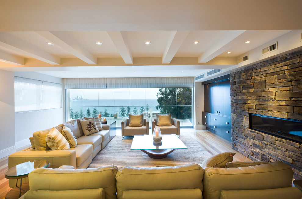 Photo of a large modern open concept living room in Gold Coast - Tweed with white walls, a ribbon fireplace and a stone fireplace surround.