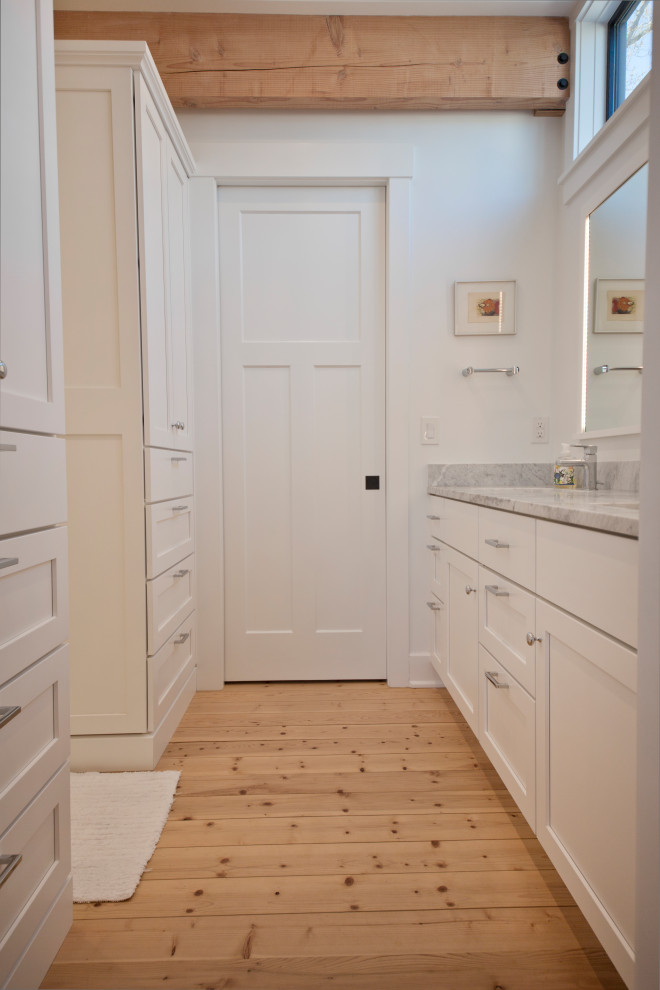 This is an example of a country bathroom in Cleveland with white cabinets, a double vanity, a built-in vanity and exposed beam.