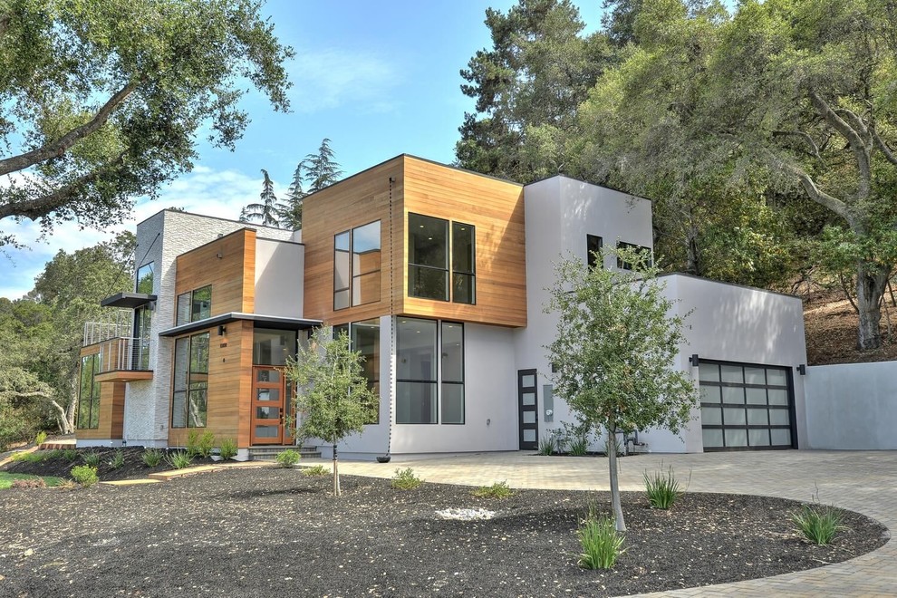 This is an example of a large contemporary two-storey grey house exterior in San Francisco with mixed siding, a flat roof and a green roof.