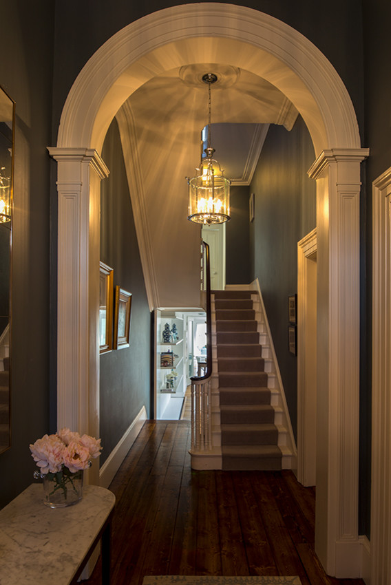 Mid-sized traditional hallway in Dublin with blue walls, dark hardwood floors and brown floor.