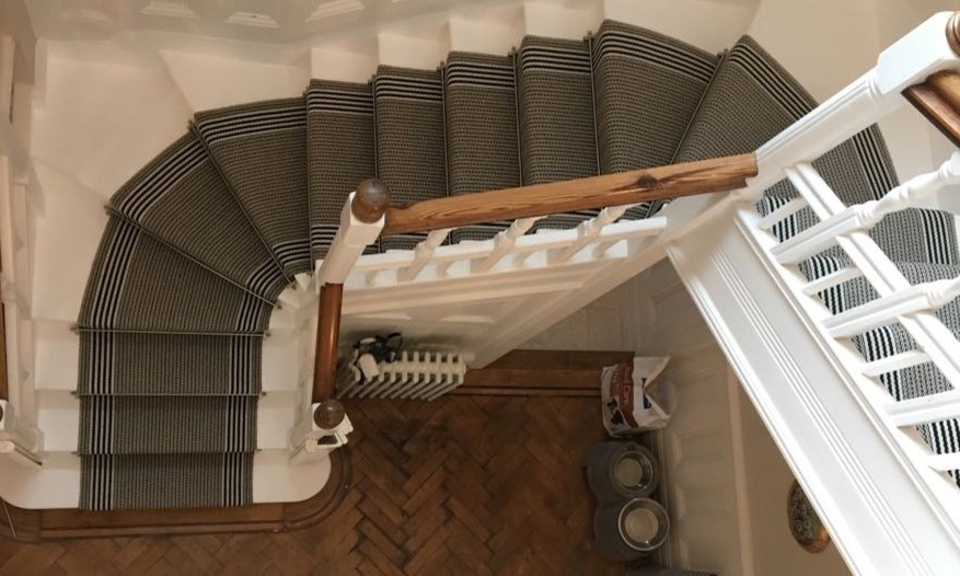 Photo of a mid-sized wood curved staircase in Berkshire with wood risers and wood railing.