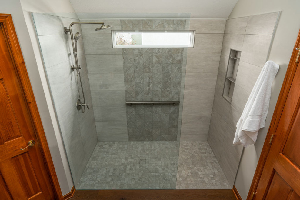Example of a large transitional master beige tile and porcelain tile medium tone wood floor and brown floor alcove shower design in Columbus with white walls