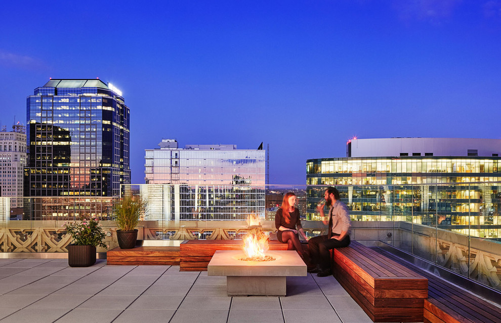 Large contemporary roof terrace in Surrey with a fire feature and no cover.