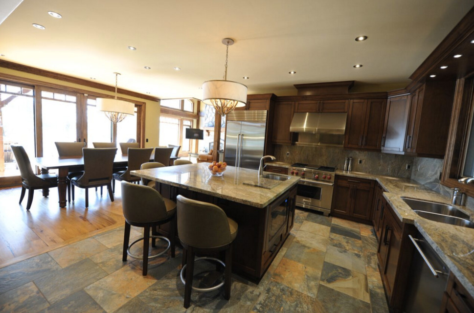 Open concept kitchen - large rustic galley dark wood floor open concept kitchen idea in Boston with an undermount sink, shaker cabinets, white cabinets, granite countertops, stainless steel appliances and an island