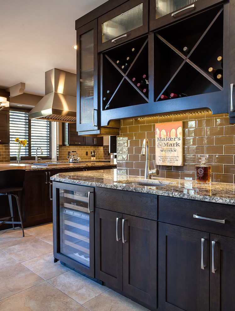 Photo of an expansive arts and crafts u-shaped open plan kitchen in Denver with an undermount sink, shaker cabinets, dark wood cabinets, granite benchtops, brown splashback, glass tile splashback, stainless steel appliances, ceramic floors and with island.