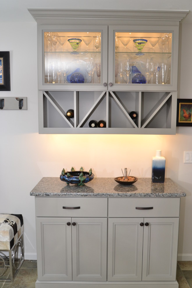 Small contemporary l-shaped eat-in kitchen in Philadelphia with an undermount sink, flat-panel cabinets, grey cabinets, granite benchtops, grey splashback, mosaic tile splashback, stainless steel appliances, terra-cotta floors and with island.