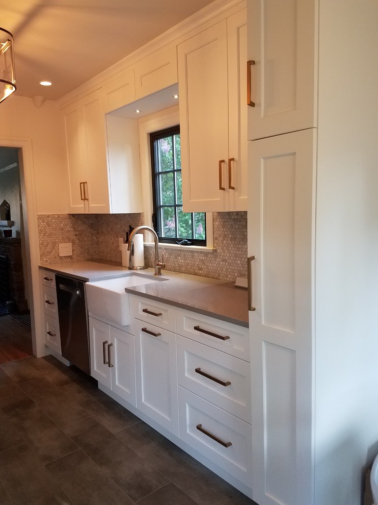 Mid-sized transitional galley porcelain tile and gray floor eat-in kitchen photo in Seattle with a farmhouse sink, shaker cabinets, white cabinets, quartz countertops, multicolored backsplash, stone tile backsplash, stainless steel appliances and no island