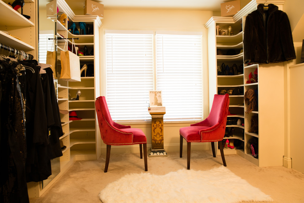 Photo of a large traditional women's dressing room in Atlanta with raised-panel cabinets, white cabinets and carpet.