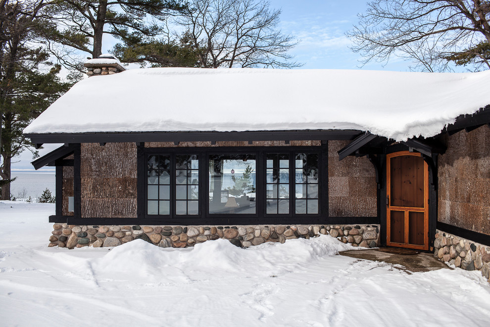 Example of a mid-sized mountain style gray one-story exterior home design in Other