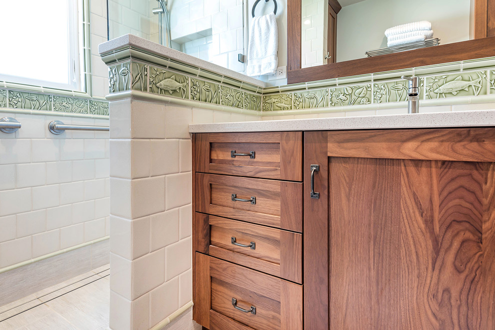Design ideas for a mid-sized arts and crafts bathroom in San Francisco with shaker cabinets, brown cabinets, a curbless shower, a wall-mount toilet, yellow tile, ceramic tile, white walls, ceramic floors, an integrated sink, engineered quartz benchtops, grey floor and grey benchtops.