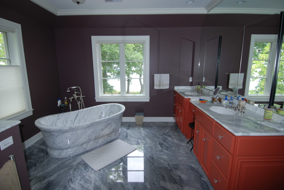 Home design - large transitional master gray tile and stone tile marble floor home design idea in Milwaukee with an undermount sink, raised-panel cabinets, red cabinets, marble countertops, a one-piece toilet and purple walls
