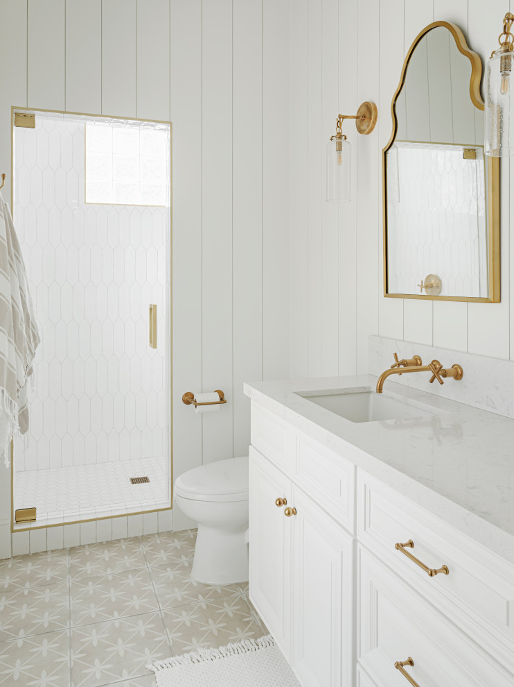 This is an example of a large traditional family bathroom in Phoenix with raised-panel cabinets, white cabinets, a walk-in shower, a one-piece toilet, white tiles, white walls, cement flooring, a submerged sink, engineered stone worktops, grey floors, a hinged door, white worktops, a shower bench, a single sink, a built in vanity unit, a timber clad ceiling and panelled walls.