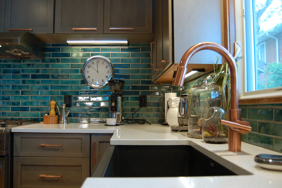 Transitional l-shaped light wood floor and multicolored floor open concept kitchen photo with a farmhouse sink, shaker cabinets, gray cabinets, quartzite countertops, blue backsplash, ceramic backsplash, stainless steel appliances and an island