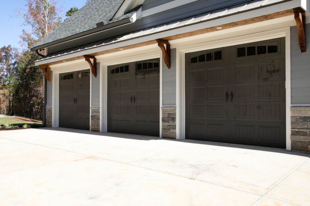 Photo of a transitional three-car garage in Atlanta.