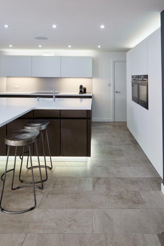 Design ideas for a medium sized contemporary kitchen/diner in Other with an integrated sink, flat-panel cabinets, brown cabinets, composite countertops, grey splashback, glass sheet splashback, integrated appliances, an island and white worktops.