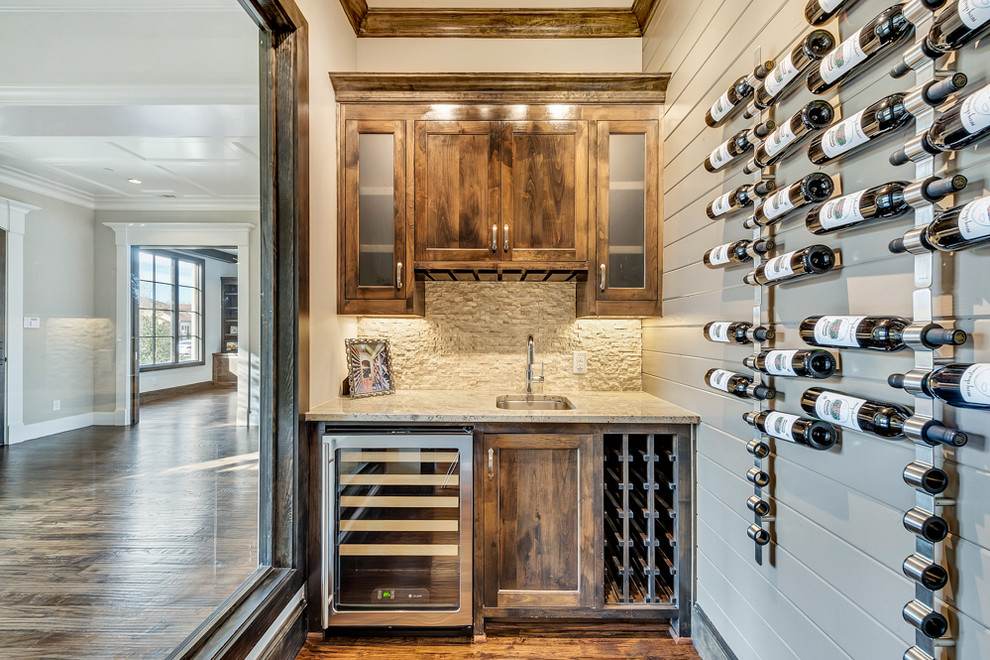 Mid-sized transitional wine cellar in Dallas with medium hardwood floors and storage racks.