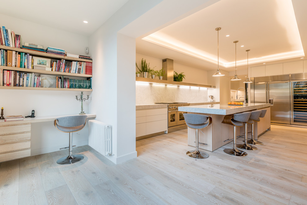 Inspiration for an expansive contemporary kitchen in Barcelona with recessed-panel cabinets, white splashback, with island, white cabinets, marble benchtops, marble splashback, stainless steel appliances, light hardwood floors, beige floor and grey benchtop.