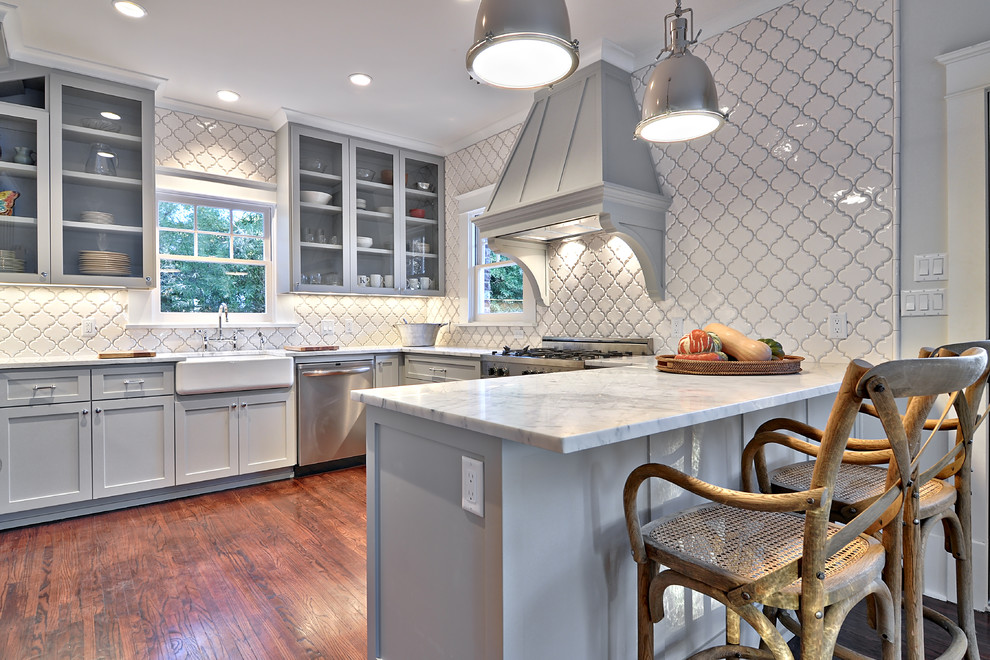 Inspiration for a traditional kitchen in Austin with a farmhouse sink, shaker cabinets, grey cabinets, white splashback, stainless steel appliances and marble benchtops.