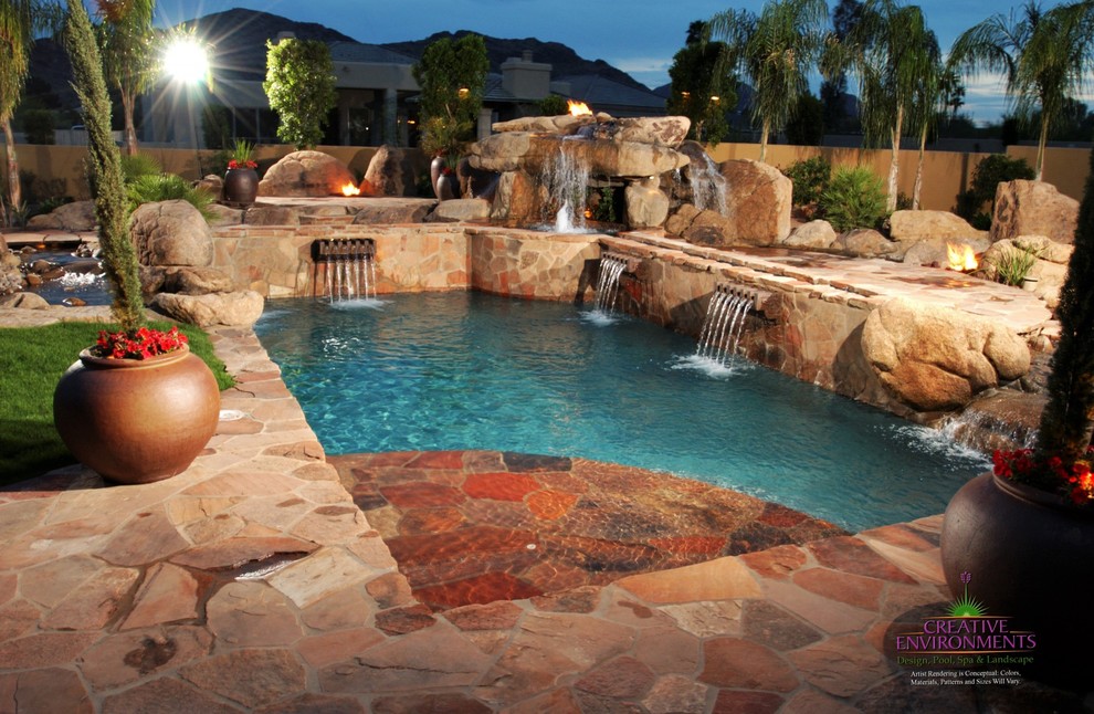 Example of a large backyard stamped concrete and custom-shaped hot tub design in Phoenix
