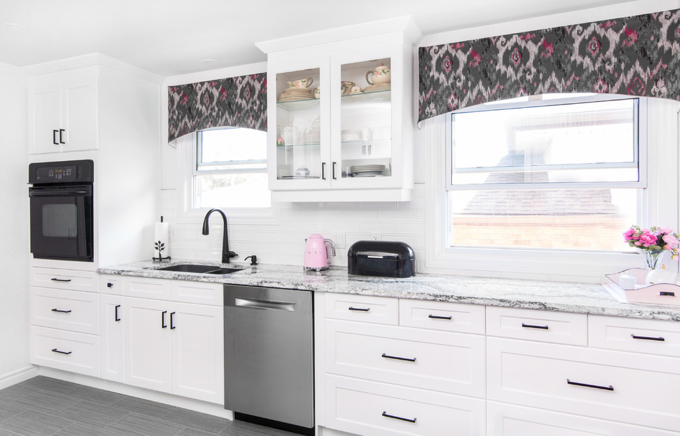 Eat-in kitchen - mid-sized transitional galley porcelain tile and gray floor eat-in kitchen idea with a double-bowl sink, shaker cabinets, white cabinets, granite countertops, white backsplash, subway tile backsplash, stainless steel appliances, no island and gray countertops