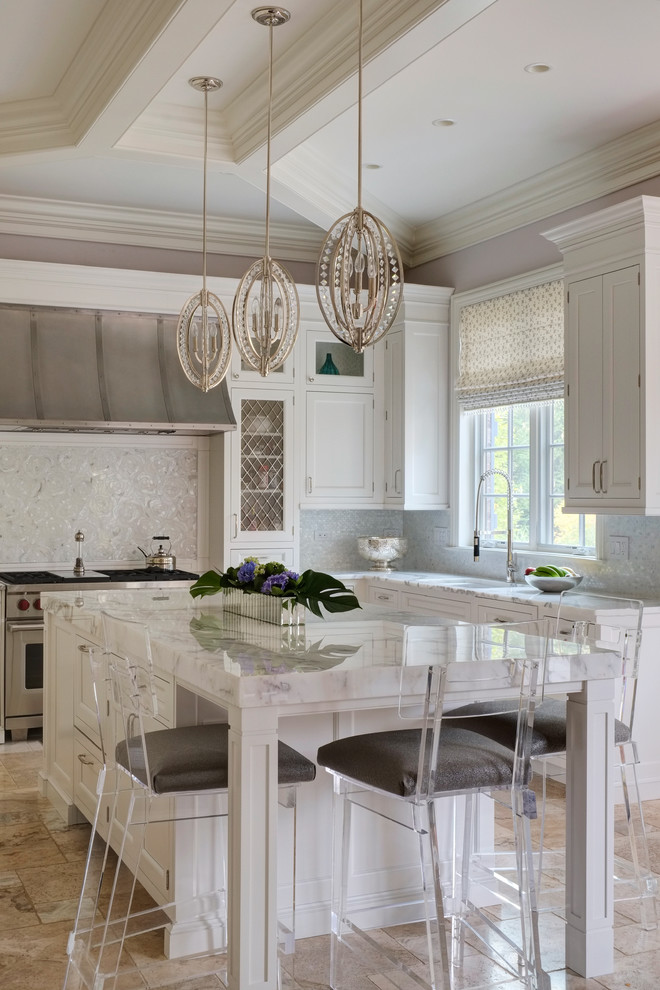 Inspiration for a transitional l-shaped kitchen in Chicago with shaker cabinets, white cabinets, white splashback, mosaic tile splashback, stainless steel appliances and with island.