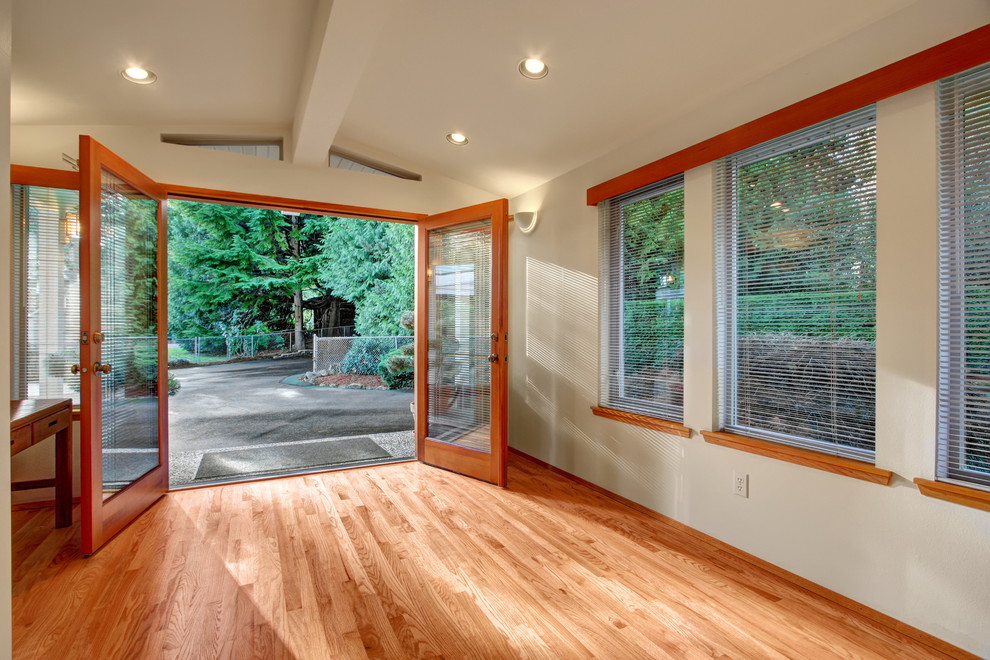 Design ideas for a large contemporary foyer in Seattle with white walls, light hardwood floors, a double front door and a medium wood front door.