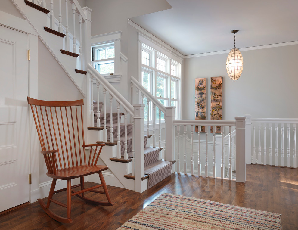 Traditional staircase in Boston with wood railing.