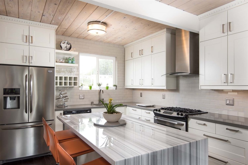 Mid-sized contemporary l-shaped eat-in kitchen in San Diego with a single-bowl sink, shaker cabinets, white cabinets, marble benchtops, grey splashback, ceramic splashback, stainless steel appliances, dark hardwood floors, with island, brown floor and grey benchtop.