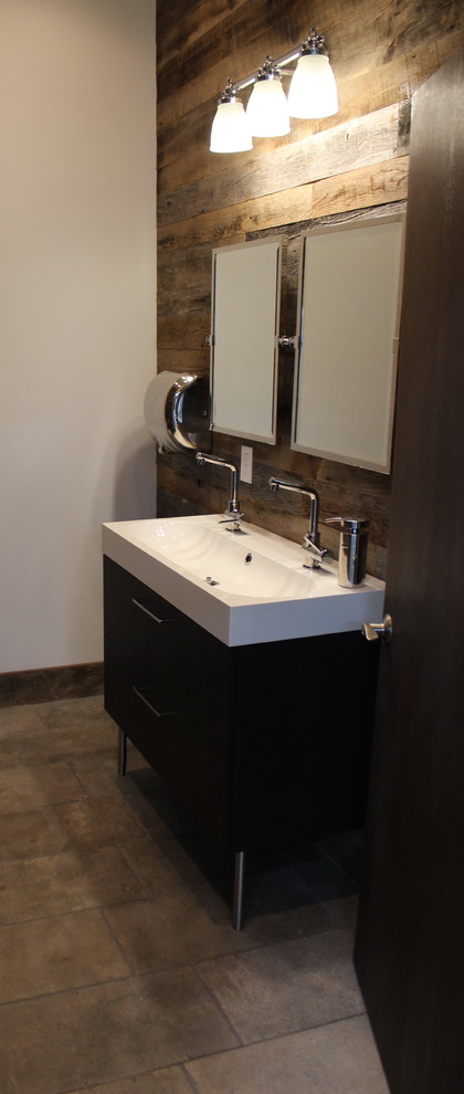 Small tuscan 3/4 gray tile and stone tile limestone floor bathroom photo with flat-panel cabinets, black cabinets, marble countertops, a two-piece toilet and white walls
