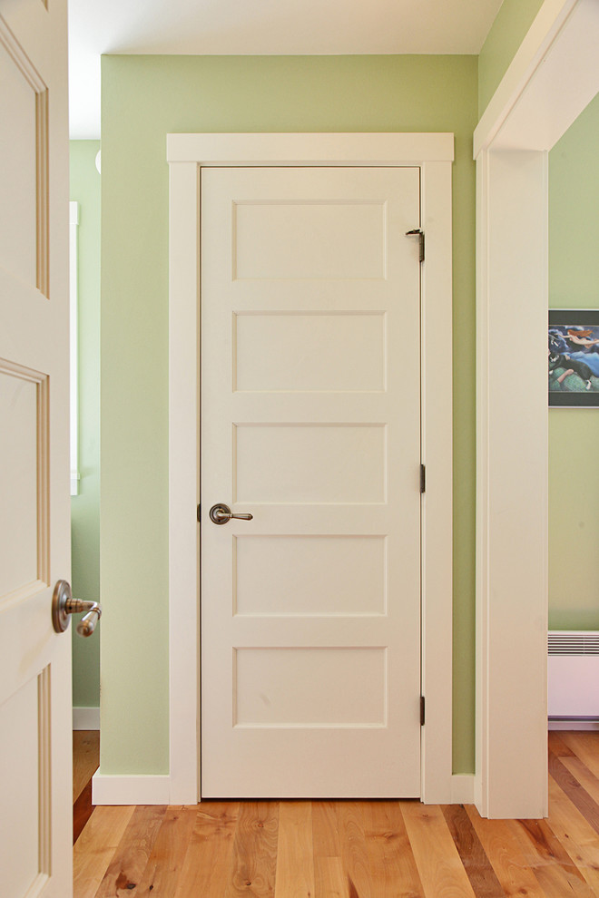 Photo of a mid-sized traditional hallway in Seattle with green walls and light hardwood floors.