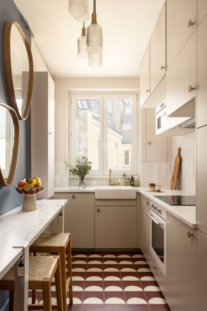 Inspiration for a small scandi single-wall enclosed kitchen in Paris with a submerged sink, marble worktops, white splashback, ceramic splashback, stainless steel appliances, slate flooring, red floors and white worktops.