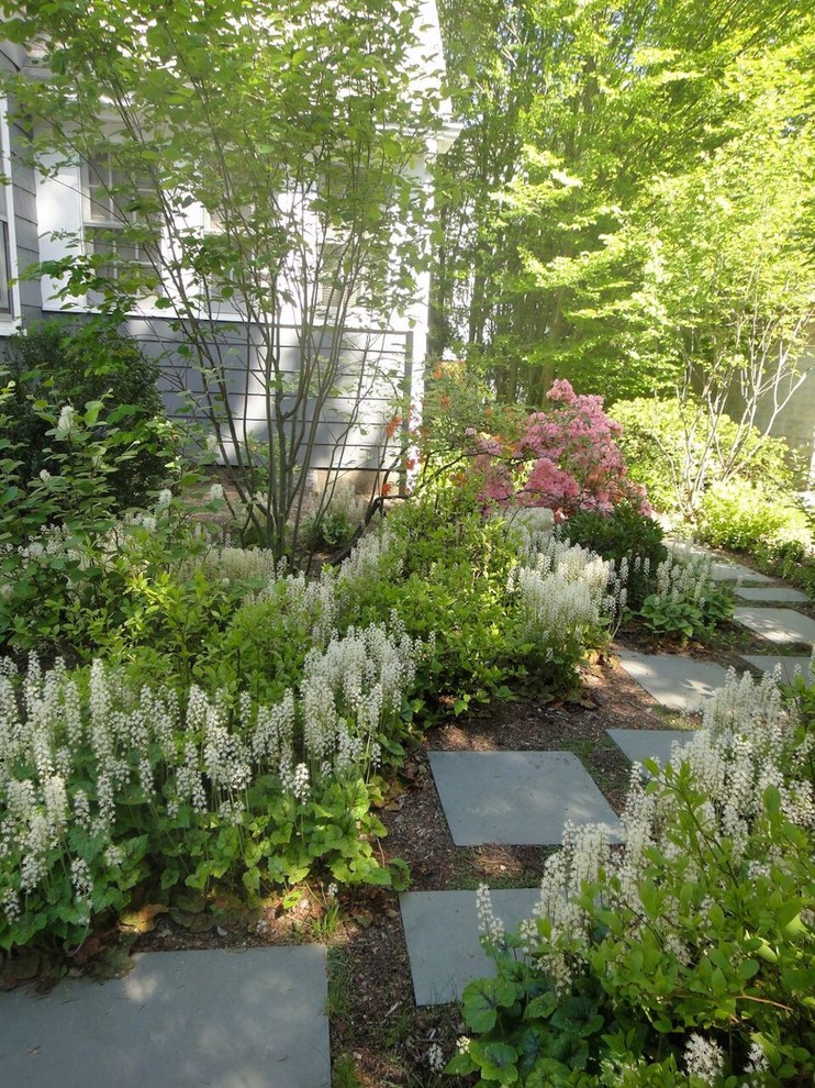 This is an example of a mid-sized traditional partial sun side yard stone garden path in Boston for spring.