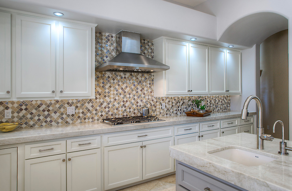 Inspiration for a large u-shaped open concept kitchen remodel in Phoenix with an undermount sink, shaker cabinets, quartzite countertops, multicolored backsplash, mosaic tile backsplash, stainless steel appliances and an island