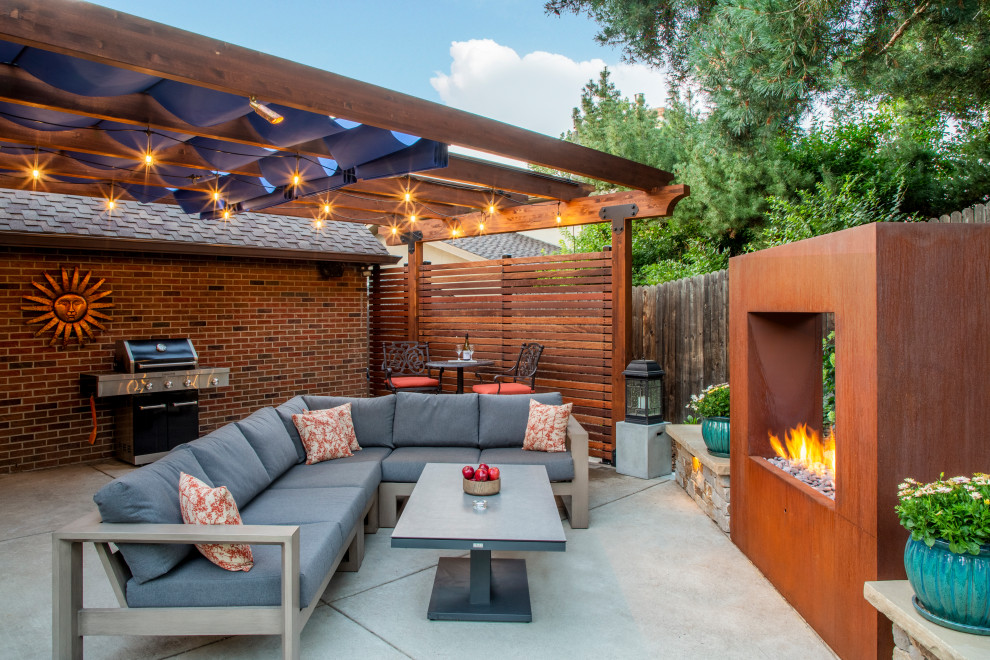 Patio - contemporary backyard concrete patio idea in Denver with a fireplace