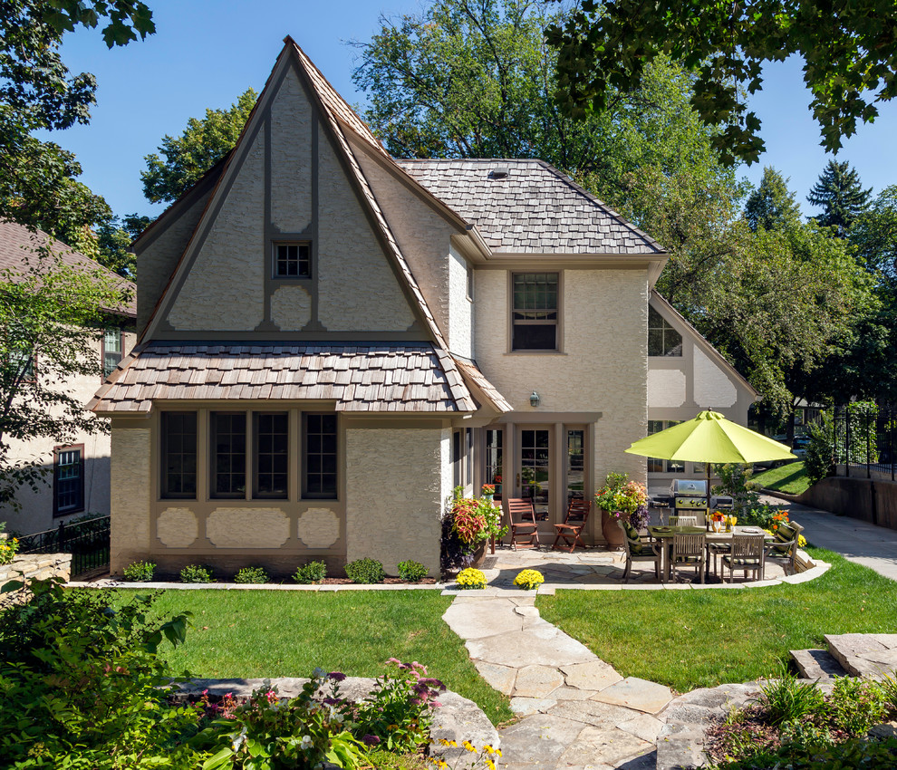 Inspiration for a mid-sized traditional two-storey stucco beige exterior in Minneapolis with a gable roof.