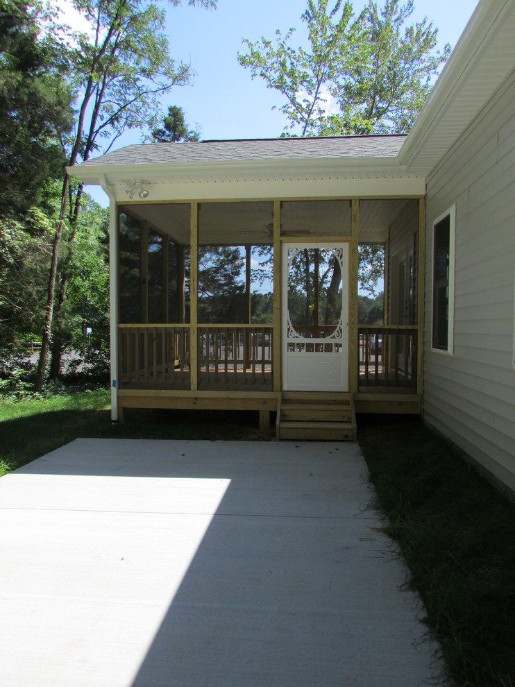 Photo of a large traditional backyard screened-in verandah in Other with decking and a roof extension.
