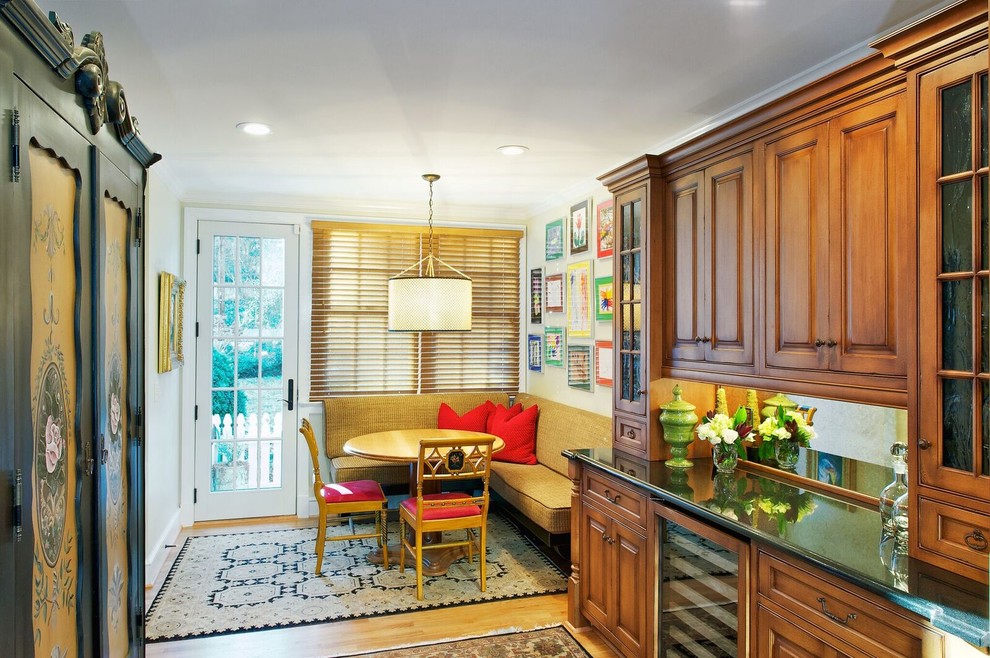 Inspiration for a mid-sized rustic l-shaped medium tone wood floor and brown floor open concept kitchen remodel in Orange County with an undermount sink, raised-panel cabinets, medium tone wood cabinets, granite countertops, beige backsplash, ceramic backsplash, stainless steel appliances and an island