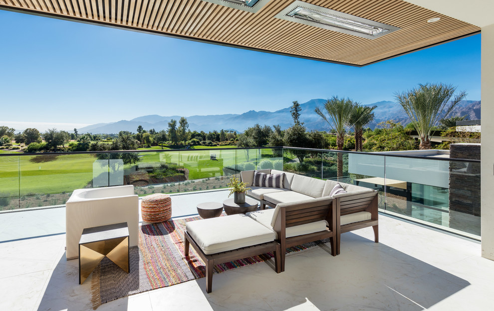 Photo of a contemporary deck in Orange County with a roof extension.
