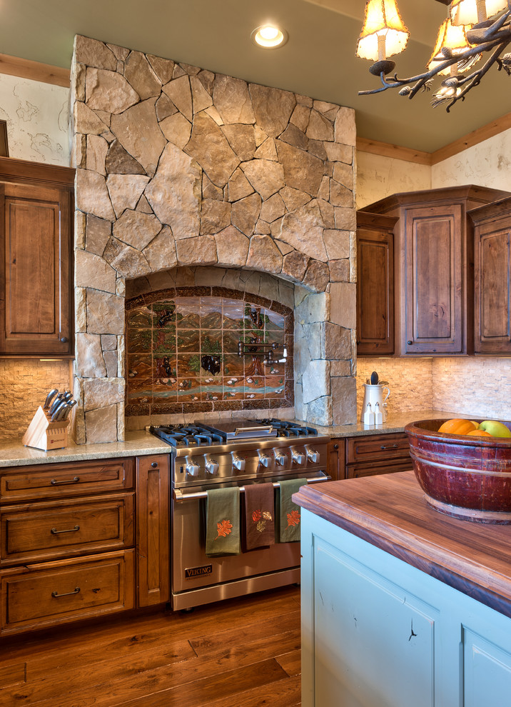 Mountain style kitchen photo with raised-panel cabinets, dark wood cabinets, wood countertops, white backsplash, stone tile backsplash and stainless steel appliances
