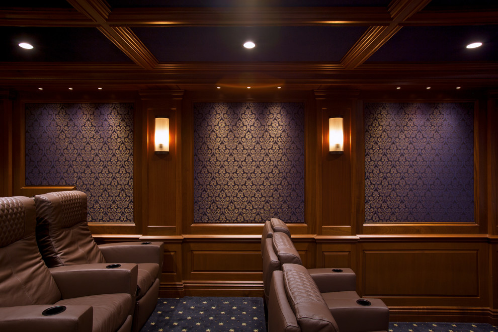 This is an example of a small traditional enclosed home theatre in New York with blue walls, carpet and a projector screen.