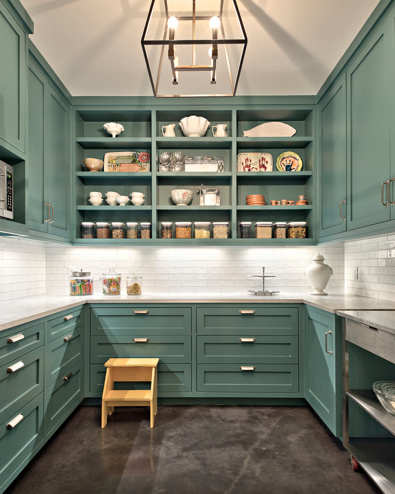 This is an example of a large country u-shaped kitchen pantry in Austin with open cabinets, white splashback, concrete floors, marble benchtops, subway tile splashback, stainless steel appliances, with island, grey floor, white benchtop and green cabinets.