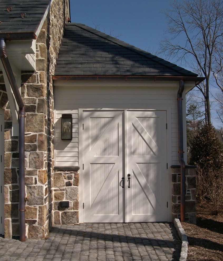 Photo of a large traditional detached two-car garage in Other.